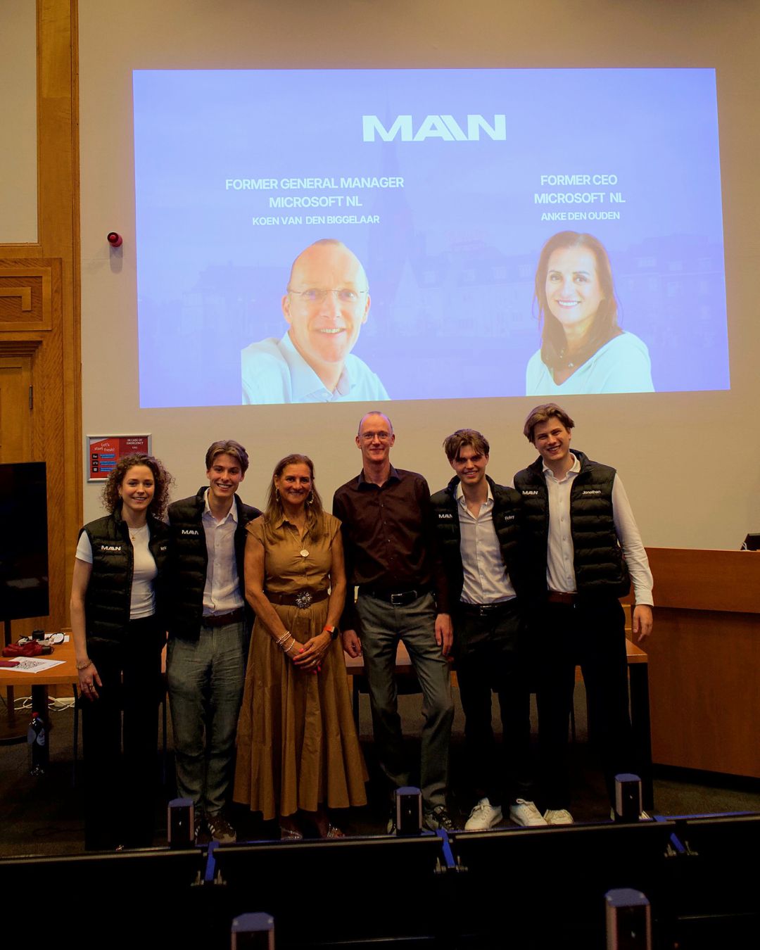 The MAIN board on stage in Maastricht after the keynote, in front of a slide announcing the two Microsoft Netherlands speakers.